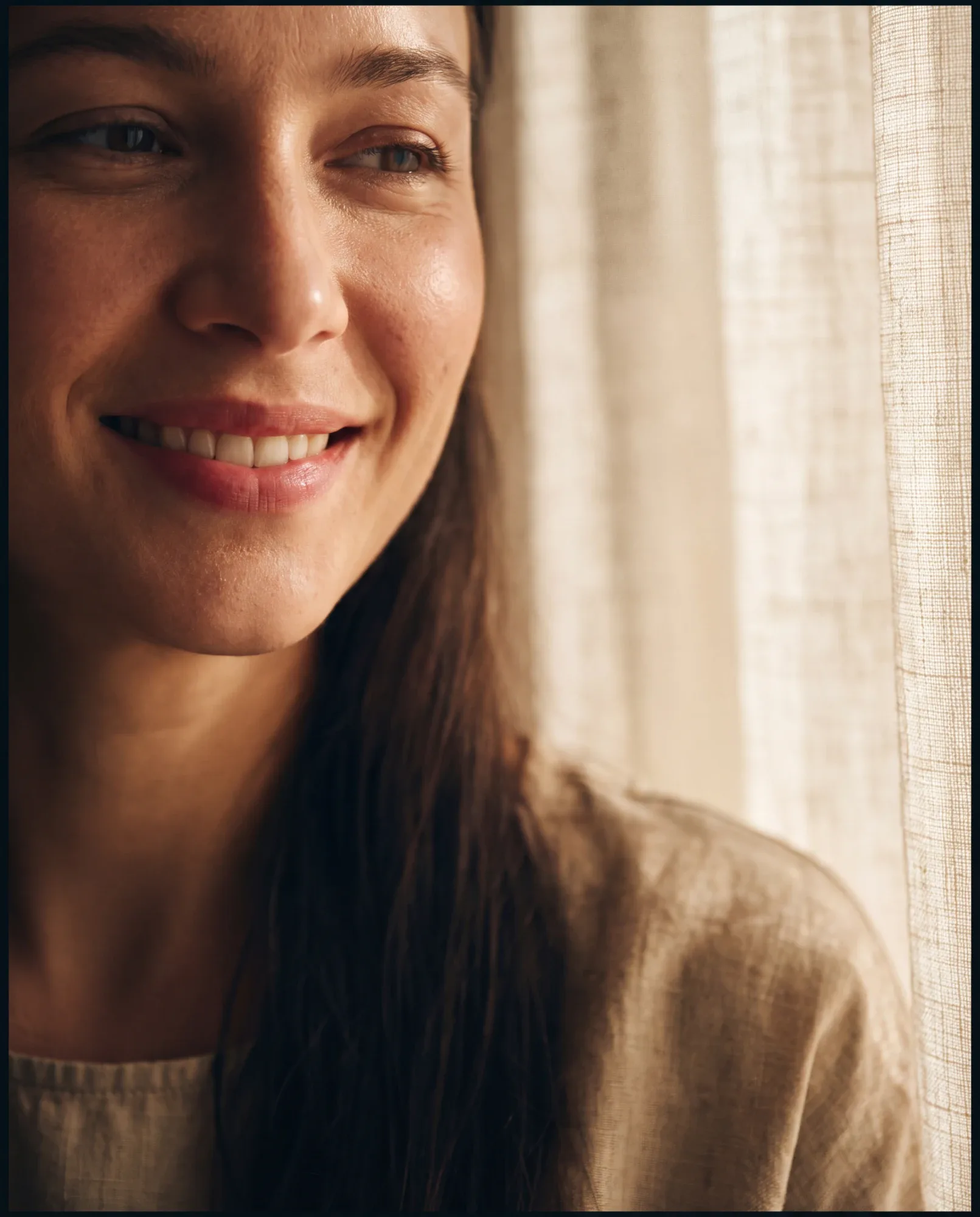 A smiling client in soft window light